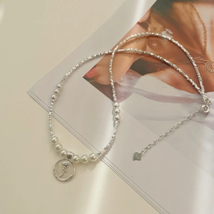 Detail of S925 sterling silver heart tag and rose pendant on pearl necklace