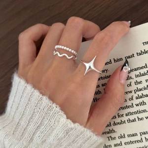 Three-piece S925 sterling silver ring set featuring star and beaded designs on hand