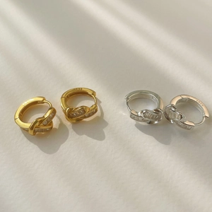 Detailed close-up of S925 sterling silver knot hoop earrings with paved cubic zirconia
