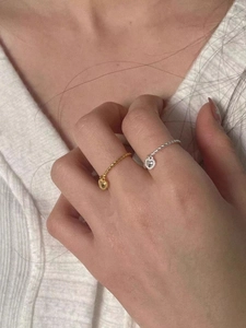 Detail of S925 silver heart charm rings with twisted rope band in gold and silver