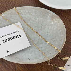Macro detail of gold-plated S925 silver bead and Figaro chains with quality hallmarks