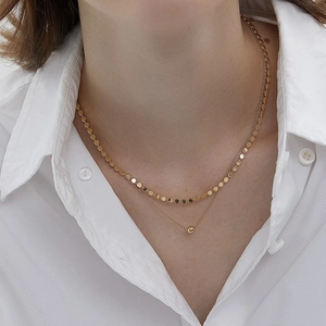 Close-up of minimalist double-layer gold S925 silver necklace on female model