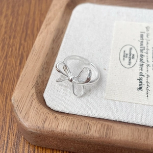 Elegant 925 sterling silver bow ring with adjustable opening and high polish finish