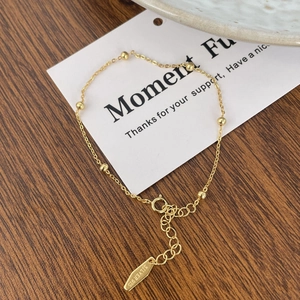 Detail of 925 sterling silver beaded chain bracelet in gold finish with extension