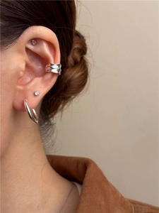 Detail view of S925 sterling silver ear cuff set with irregular wave texture and zircon