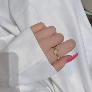 Close-up of a 925 silver gold ring with oval pink chalcedony on a model hand