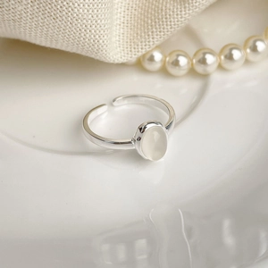 Detailed close-up of 925 sterling silver ring with oval white chalcedony stone