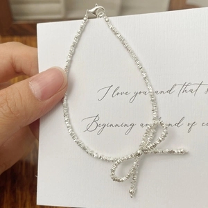 Elegant S925 sterling silver beaded bracelet with a delicate bow charm and lobster clasp