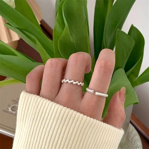 Detailed close-up of S925 silver beaded and twisted rope rings on a hand
