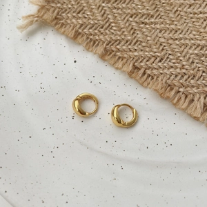 Macro shot of 18K gold-plated S925 sterling silver hoop earrings with polished finish