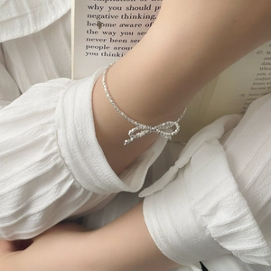 Elegant S925 silver bow bracelet on model wrist with minimalist Korean style
