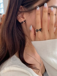 Detail of beaded bow earrings and ring set worn by model for an elegant Korean style look
