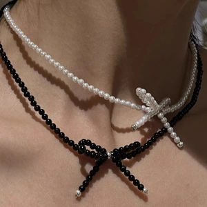 Close-up of S925 sterling silver bow knot pearl necklace worn around the neck
