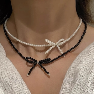 Elegant beaded bow necklaces in white pearl and black beads for a layered Korean look