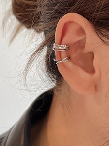 Close-up of minimalist silver X-shaped cross and parallel lines ear cuff set for women