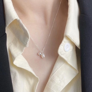 Elegant S925 silver necklace with teardrop pearl and metal ball pendant worn on neck