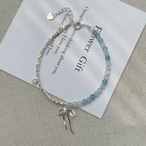 S925 sterling silver bracelet with blue beads, bow pendant and asymmetric link design
