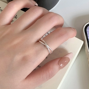 Minimalist S925 sterling silver twisted knot ring on hand with a sleek modern design