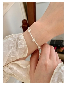 Elegant silver beaded bracelet featuring three 3D butterfly charms worn on a woman's wrist
