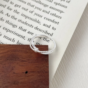 Detailed view of S925 sterling silver twisted knot ring with delicate metallic textures