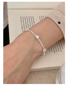 Detailed view of an S925 silver floral bracelet on wrist with a French vintage vibe