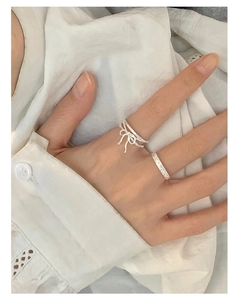 Detailed view of S925 sterling silver ribbon bow ring with textured minimalist band
