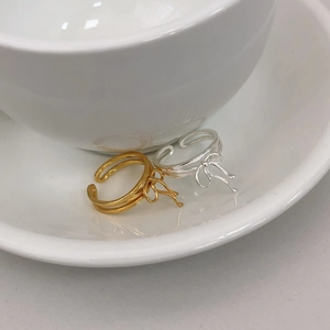 Macro shot of S925 sterling silver ribbon bow ring showing the metallic texture