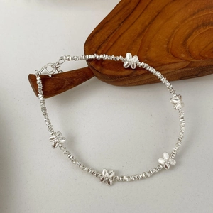Detail shot of S925 sterling silver beaded bracelet with five delicate butterfly charms