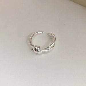 Detail of minimalist S925 sterling silver knotted ring with adjustable open design