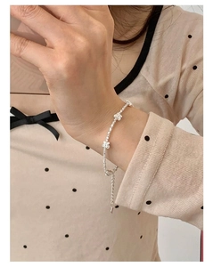 Close-up of S925 sterling silver bead bracelet with hollow flower charms and lobster clasp