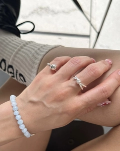 Minimalist S925 silver knot ring and bead bracelet set shown on hands for casual styling