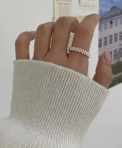 Macro shot of S925 silver multi-layer beaded ring worn by a model on a white knit cuff