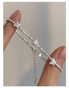 Close-up of S925 sterling silver beaded bracelet with three delicate butterfly charms