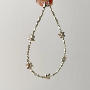 Close-up of S925 silver beaded bracelet featuring five polished butterfly charms