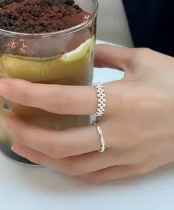 Macro view of minimalist S925 silver beaded rings in multilayer and twist designs