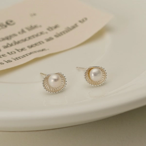 Elegant S925 silver shell-shaped earrings with round freshwater pearls on ceramic plate
