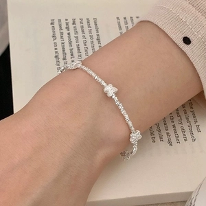 Elegant S925 sterling silver bow bracelet with textured crushed silver beads on wrist