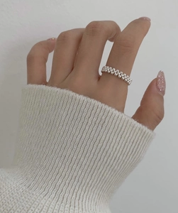 Detail of S925 sterling silver multi-layer beaded ring styled with a cozy knit sweater