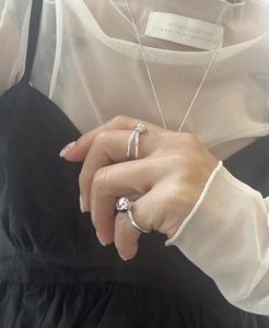 Detail showing S925 sterling silver knotted ring and ball jewelry set on model