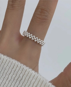Macro detail of silver multi-layered beaded minimalist ring with high-gloss finish