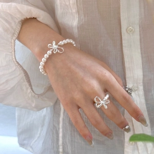 Elegant S925 silver bow jewelry set with round pearls featuring bracelet and ring