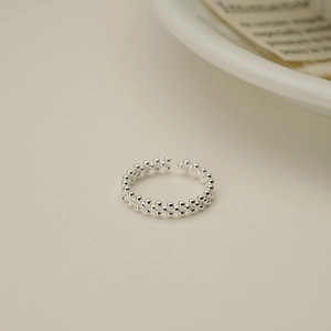 Detail of S925 sterling silver double-layered beaded ring with polished finish