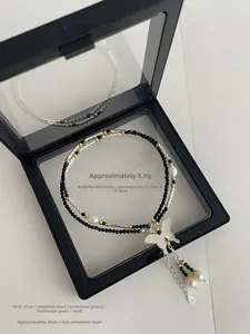 Detail of S925 silver beaded necklace with shell butterfly pendant and white pearls
