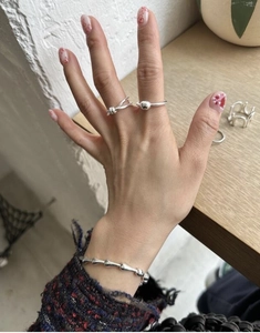 Detail view of S925 silver knot ring and bead ring with a matching bone chain bracelet