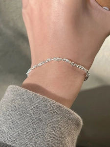 Close-up of double-layer S925 silver woven bead bracelet worn on a female wrist
