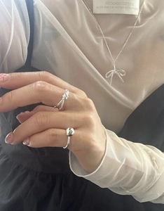 Minimalist S925 silver knot ring and bow necklace jewelry set shown on a model