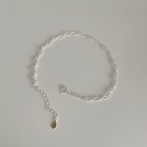 Macro shot of S925 silver double-layered woven bracelet with fine beads and lobster clasp