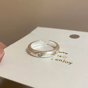 Macro detail of silver S925 star ring with matte brushed finish and zircon accents
