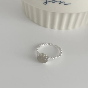 Close-up of vintage S925 silver ring with woven texture and oval grey crystal stone