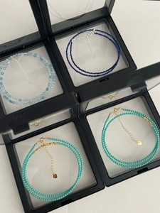 Detail of S925 silver beaded necklaces with aquamarine and lapis lazuli in a display box